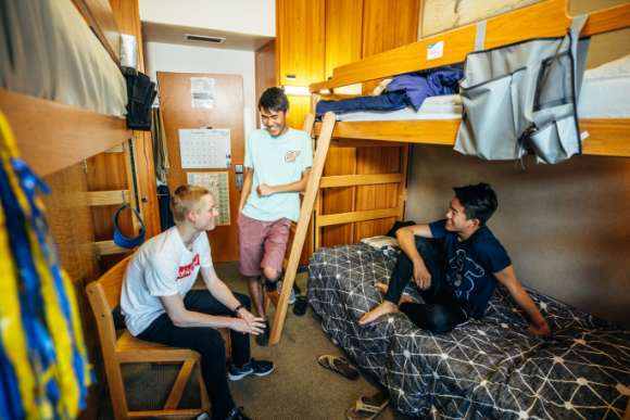 Students laughing in their dorm room